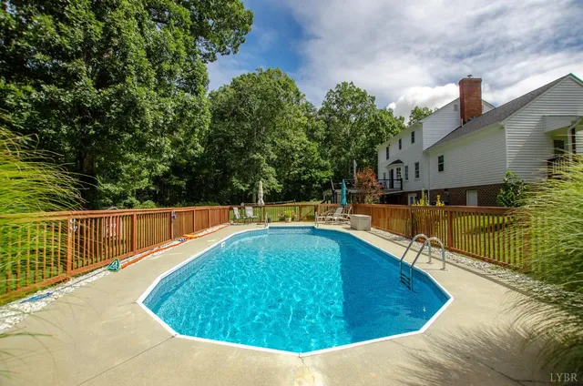 a open kitchen with kitchen island granite countertop a stove a sink a refrigerator dining table and chairs with wooden floor