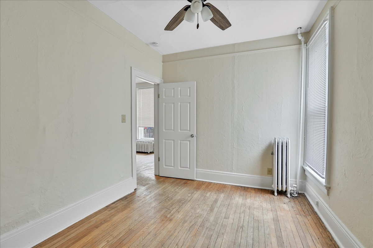 212 West High Street Urbana, IL 61801 - Photo 11 of 36 wooden floor in an empty room with a window