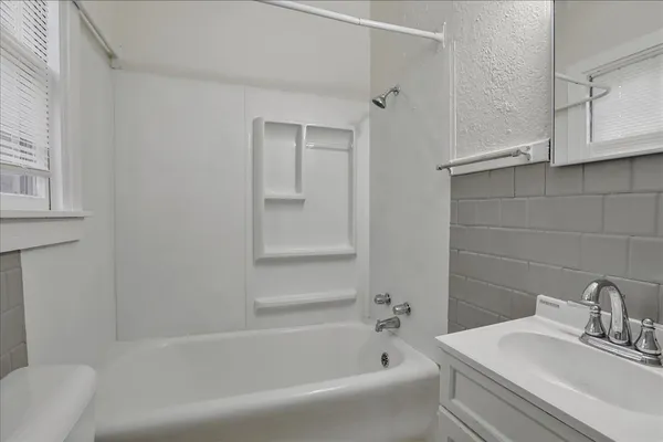 a white bath tub sitting next to a white sink