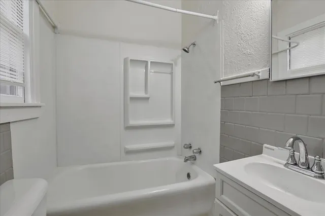 a white bath tub sitting next to a white sink