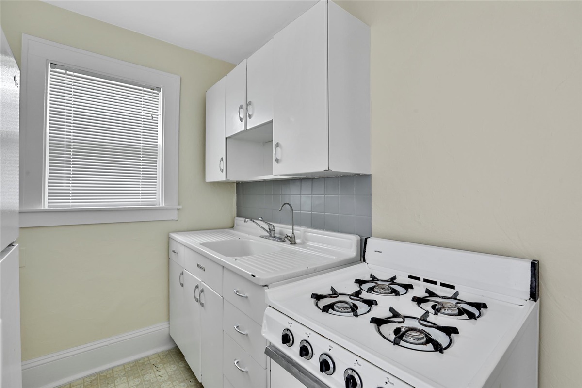 212 West High Street Urbana, IL 61801 - Photo 20 of 36 a kitchen with white cabinets and white appliances