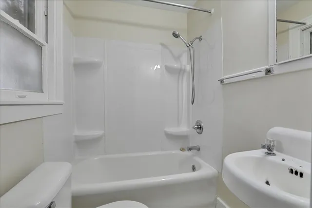 a bathroom with a bathtub and a toilet