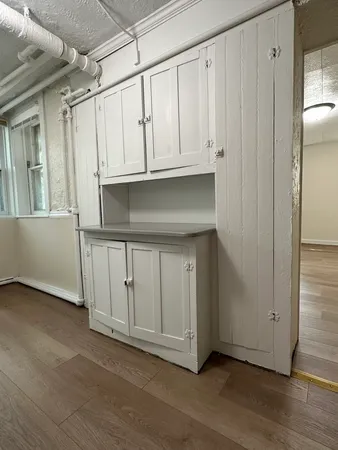 a view of a utility room with cabinets