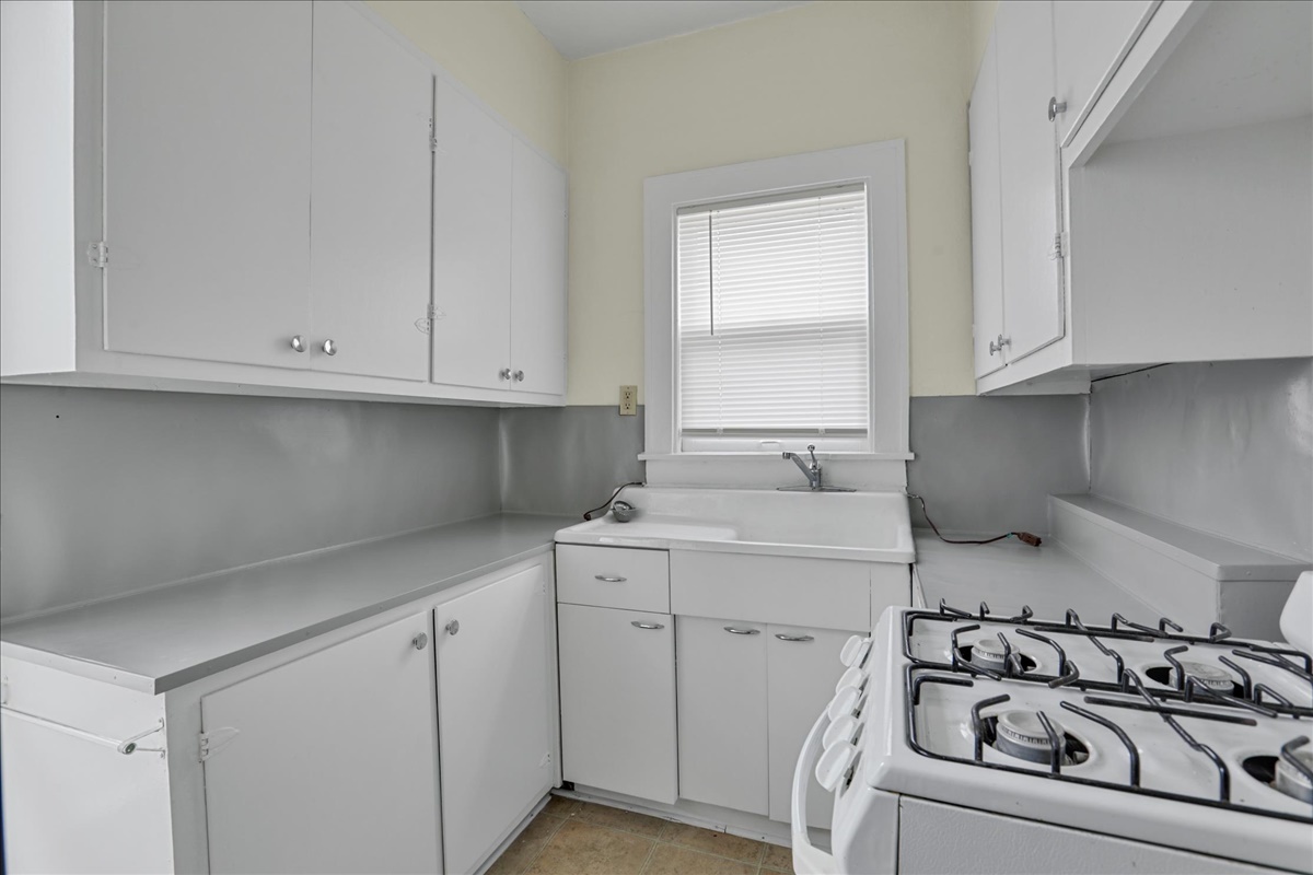 212 West High Street Urbana, IL 61801 - Photo 8 of 36 a kitchen with white cabinets and sink
