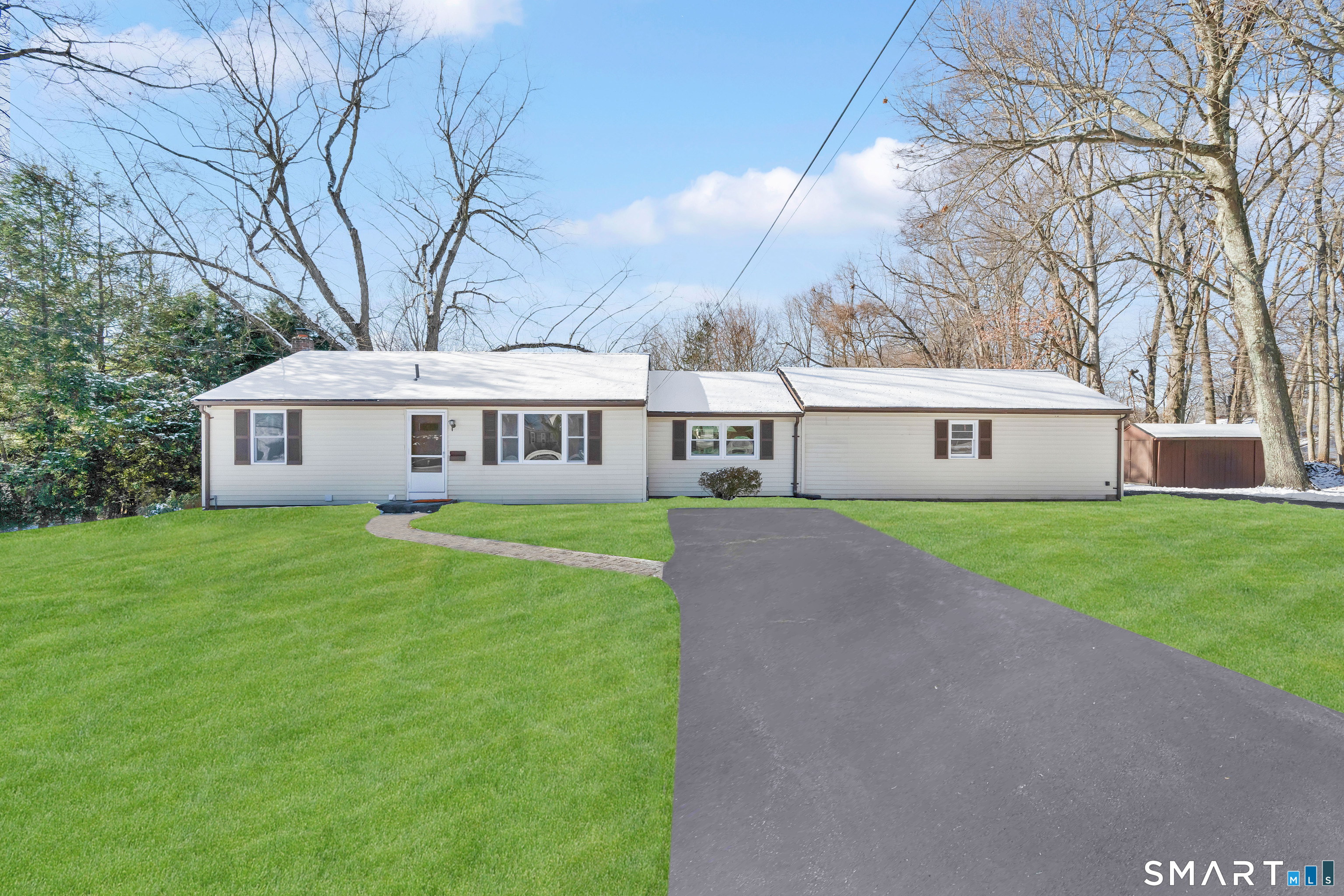 a front view of house with yard and green space