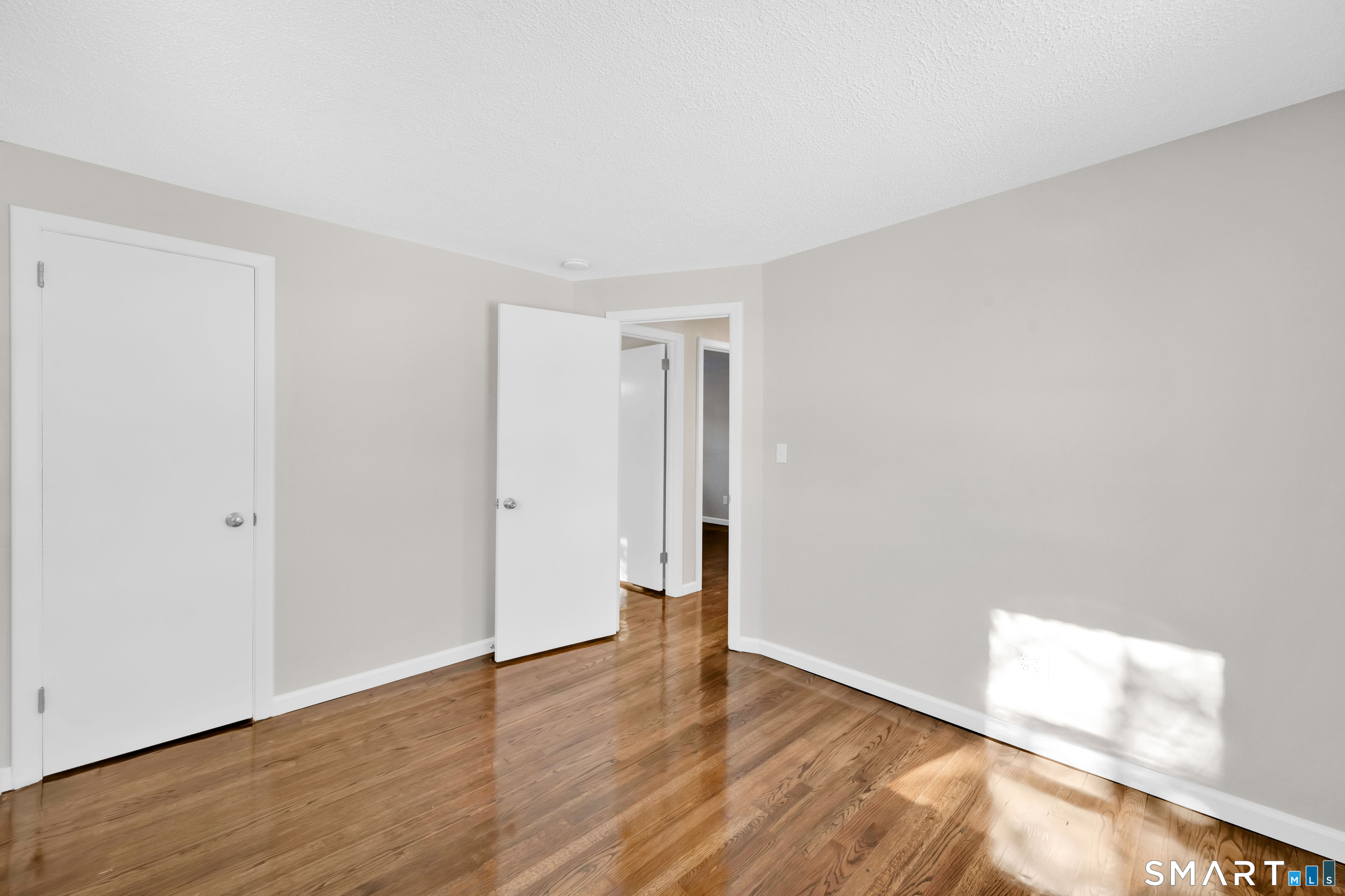 23 Bancroft Road Vernon, CT 06066 - Photo 12 of 20 a view of an empty room with wooden floor and closet