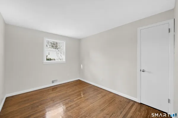 a view of a room with wooden floor and window