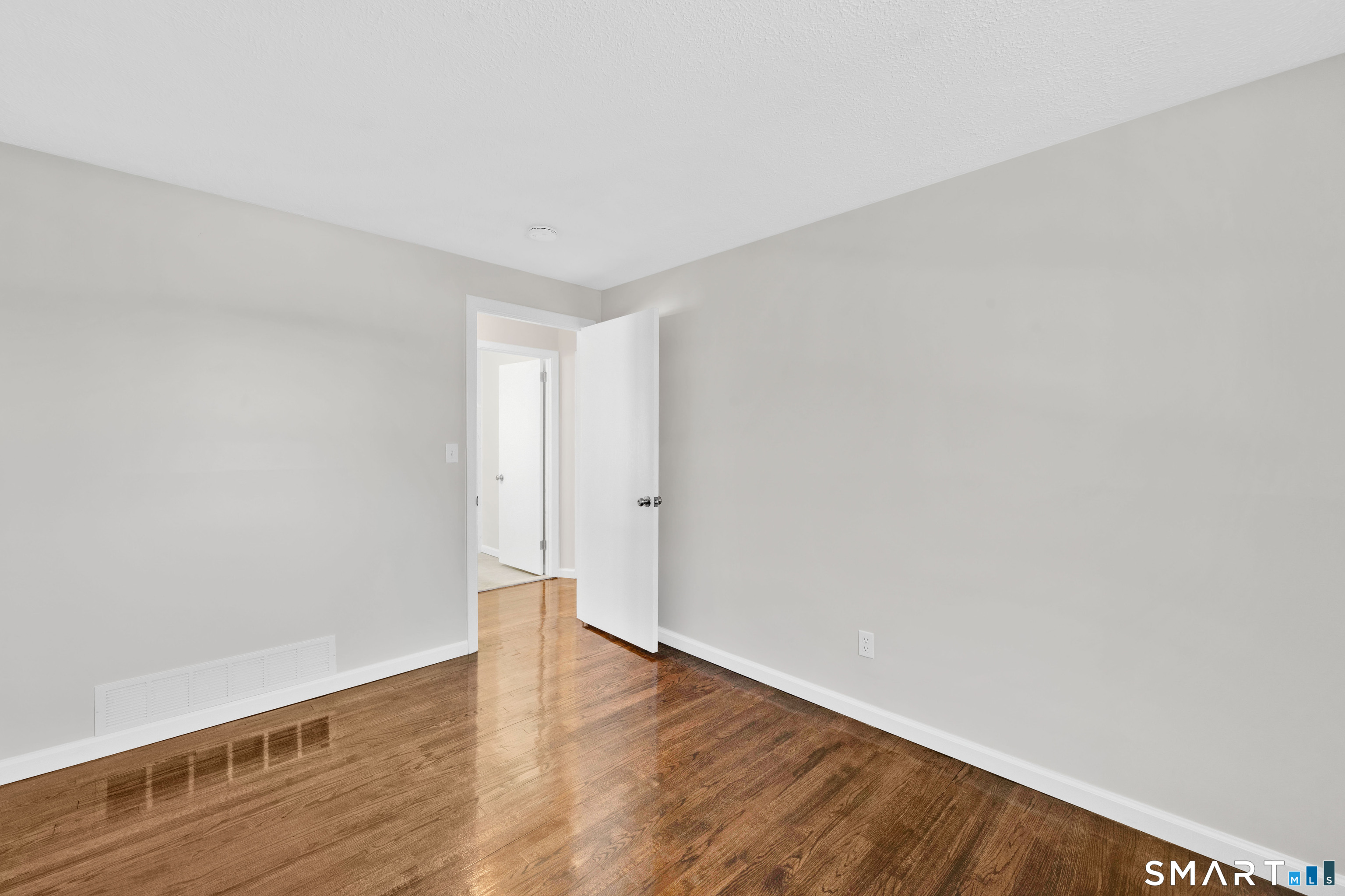 23 Bancroft Road Vernon, CT 06066 - Photo 14 of 20 a view of an empty room with wooden floor