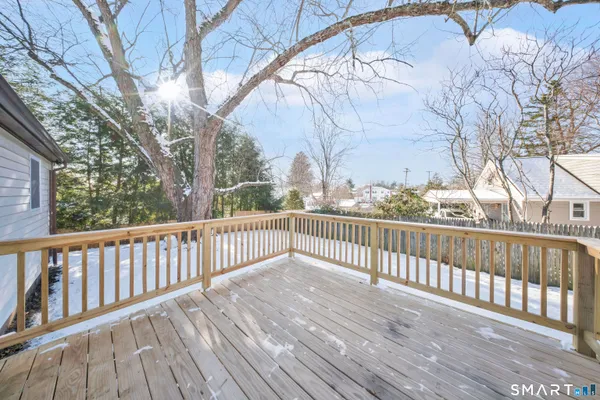 a view of balcony with wooden floor and fence