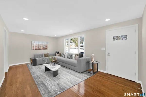 a living room with furniture and wooden floor