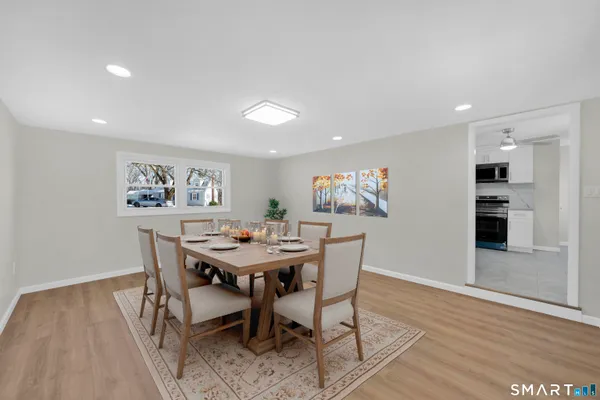 a view of a dining room with furniture and wooden floor