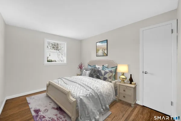 a bedroom with a bed and a painting on the wall