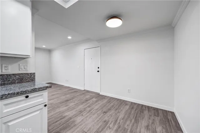 a view of kitchen with granite countertop cabinets and wooden floor