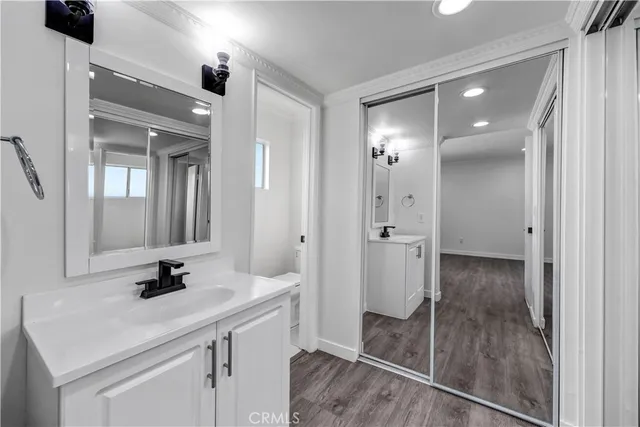 a bathroom with a sink shower and a mirror