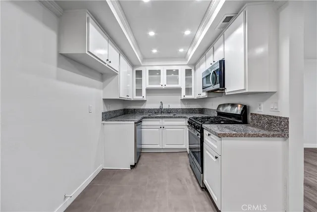 a kitchen with stainless steel appliances granite countertop a stove and a sink
