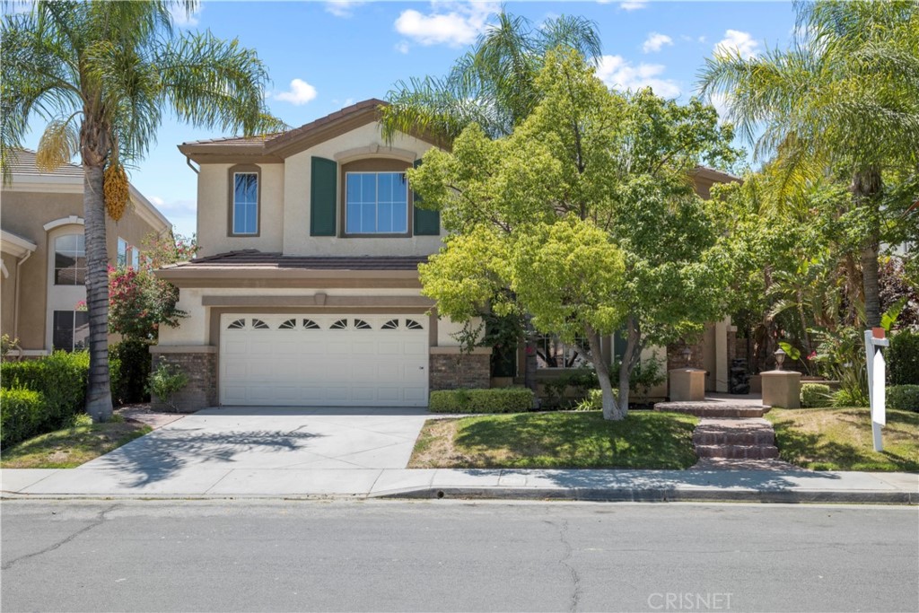 28570 Horseshoe Circle Saugus, CA 91390 - Photo 2 of 2 a front view of a house with a garden and trees