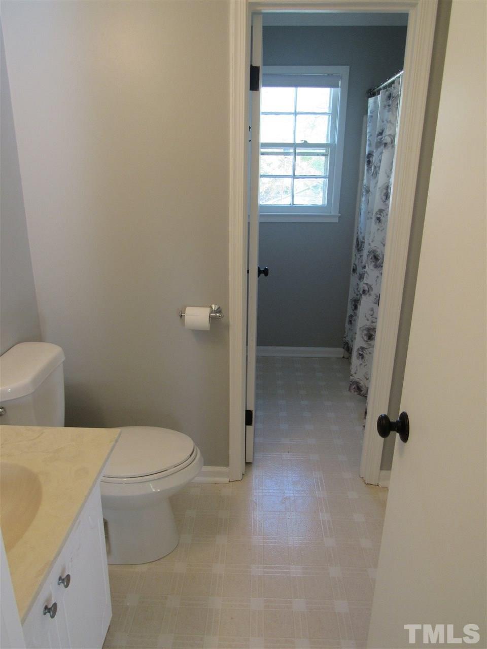 7404 Archer Circle Raleigh, NC 27615 - Photo 17 of 25 a bathroom with a toilet and a shower