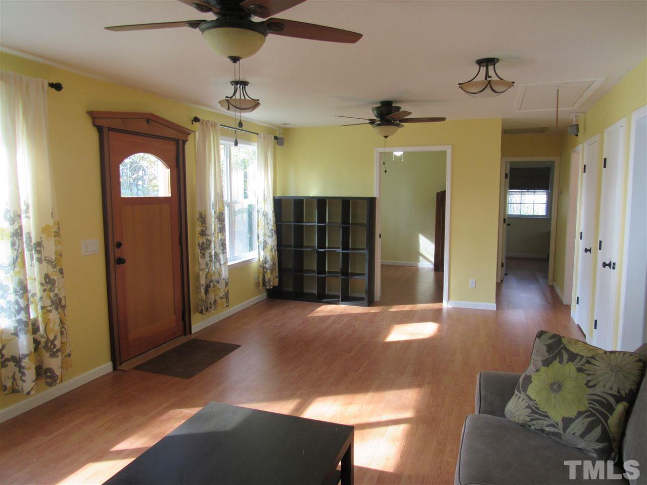 7404 Archer Circle Raleigh, NC 27615 - Photo 3 of 25 a view of a livingroom with a chandelier fan and windows