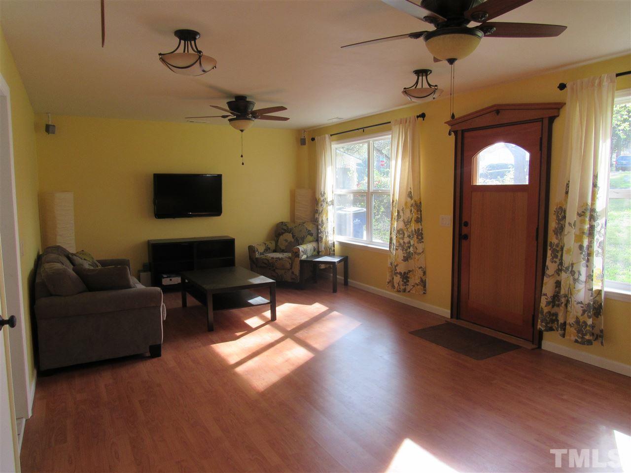 7404 Archer Circle Raleigh, NC 27615 - Photo 5 of 25 a living room with furniture and a flat screen tv