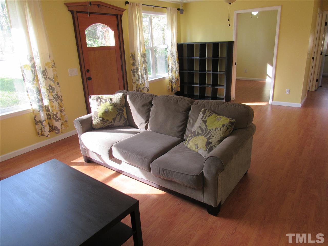 7404 Archer Circle Raleigh, NC 27615 - Photo 8 of 25 a living room with furniture and wooden floor