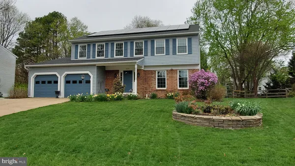 a front view of a house with a garden and yard