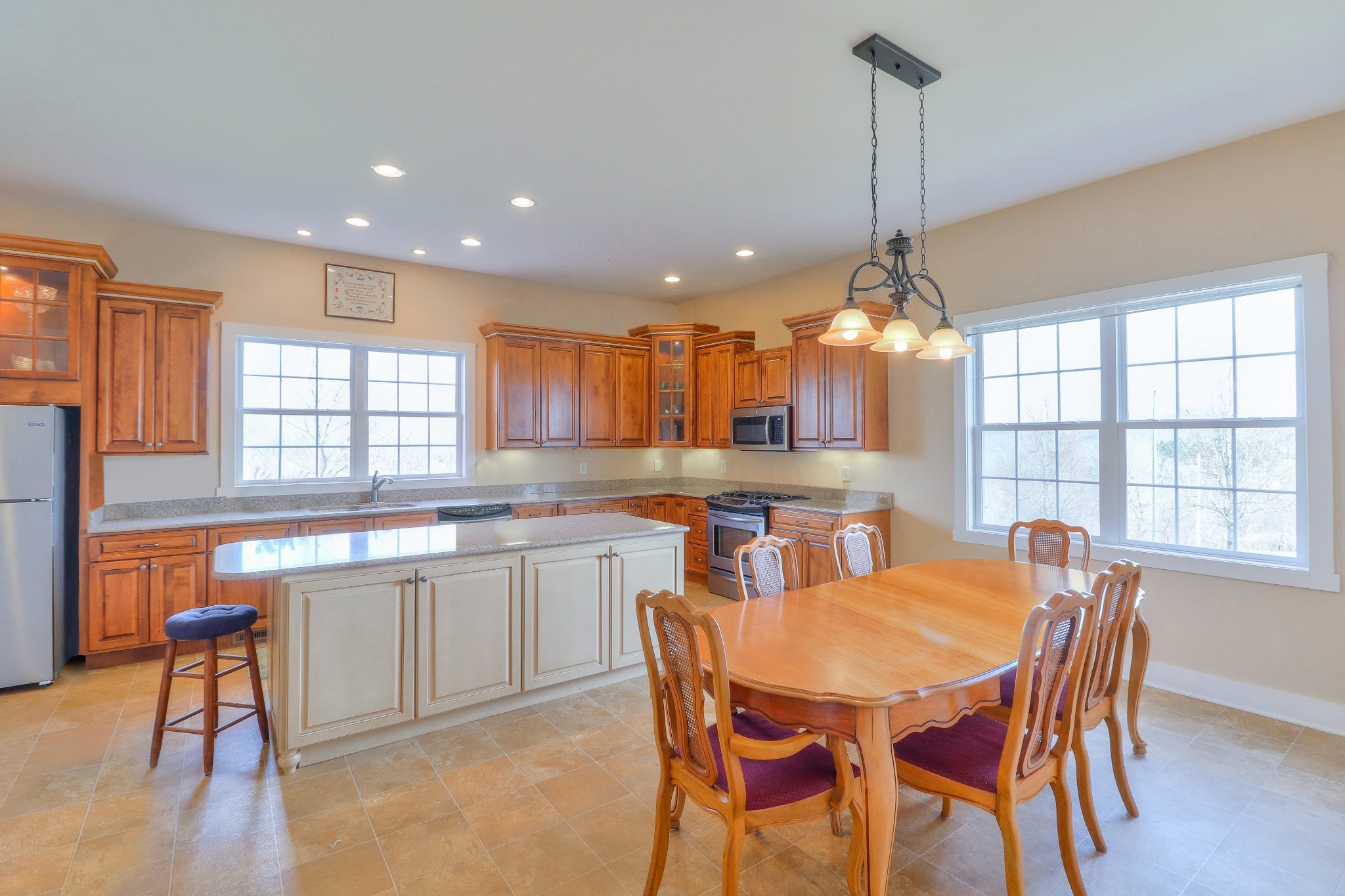 1298 Berea Church Road Lebanon, TN 37087 - Photo 11 of 50 a dining room with stainless steel appliances granite countertop a sink a stove a table and chairs