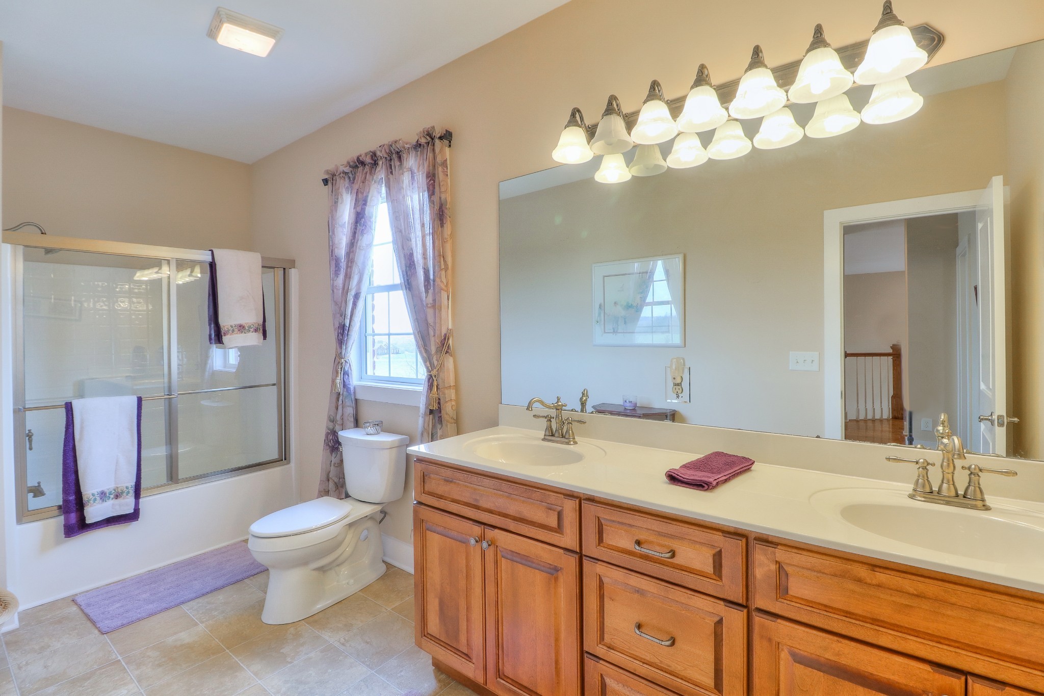1298 Berea Church Road Lebanon, TN 37087 - Photo 34 of 50 a bathroom with a granite countertop double vanity sink toilet and shower