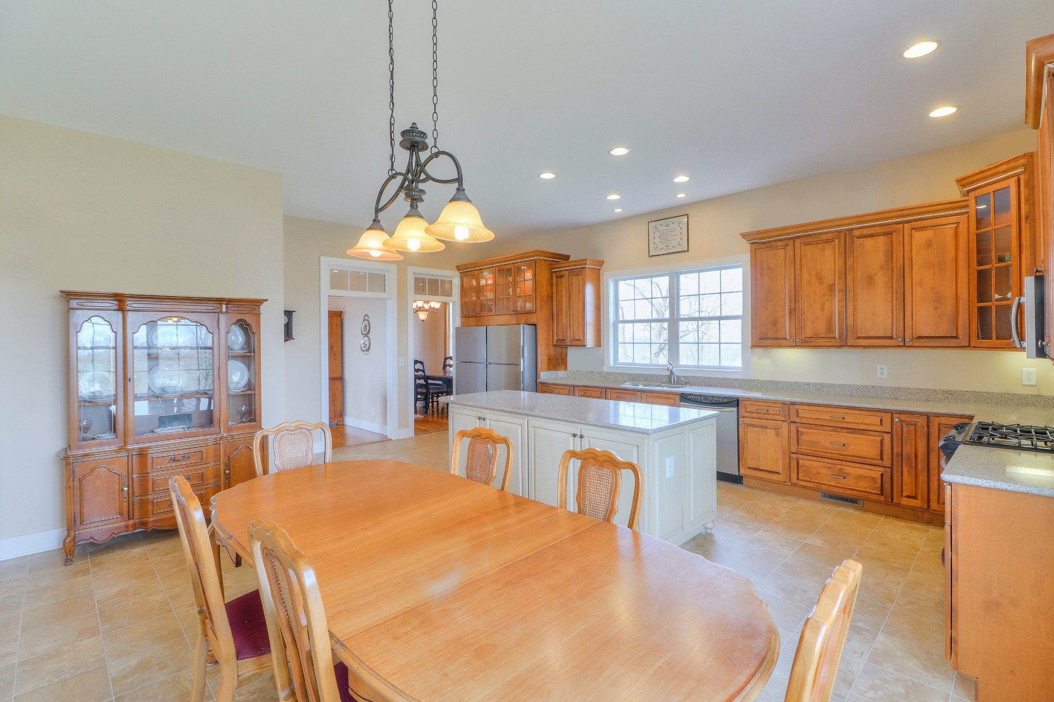 1298 Berea Church Road Lebanon, TN 37087 - Photo 10 of 50 a large kitchen with kitchen island a large window cabinets and stainless steel appliances