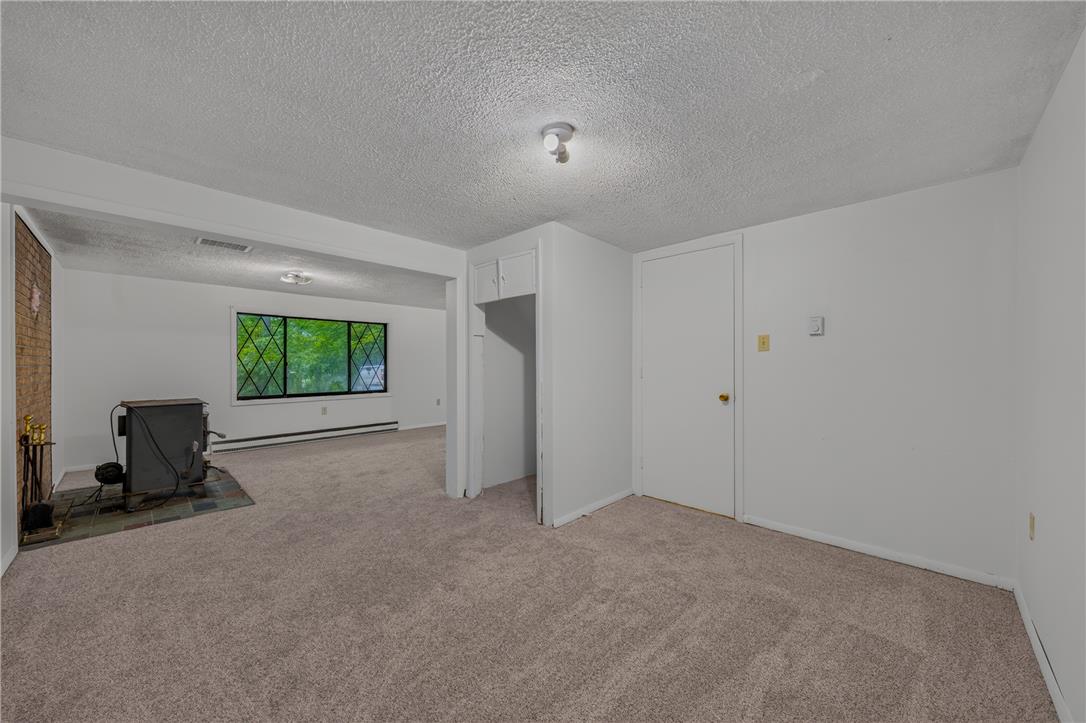 1570 Astolat Road Effort, PA 18330 - Photo 11 of 48 Plush wall-to-wall carpeting and neutral walls ground this versatile, open-concept living space.