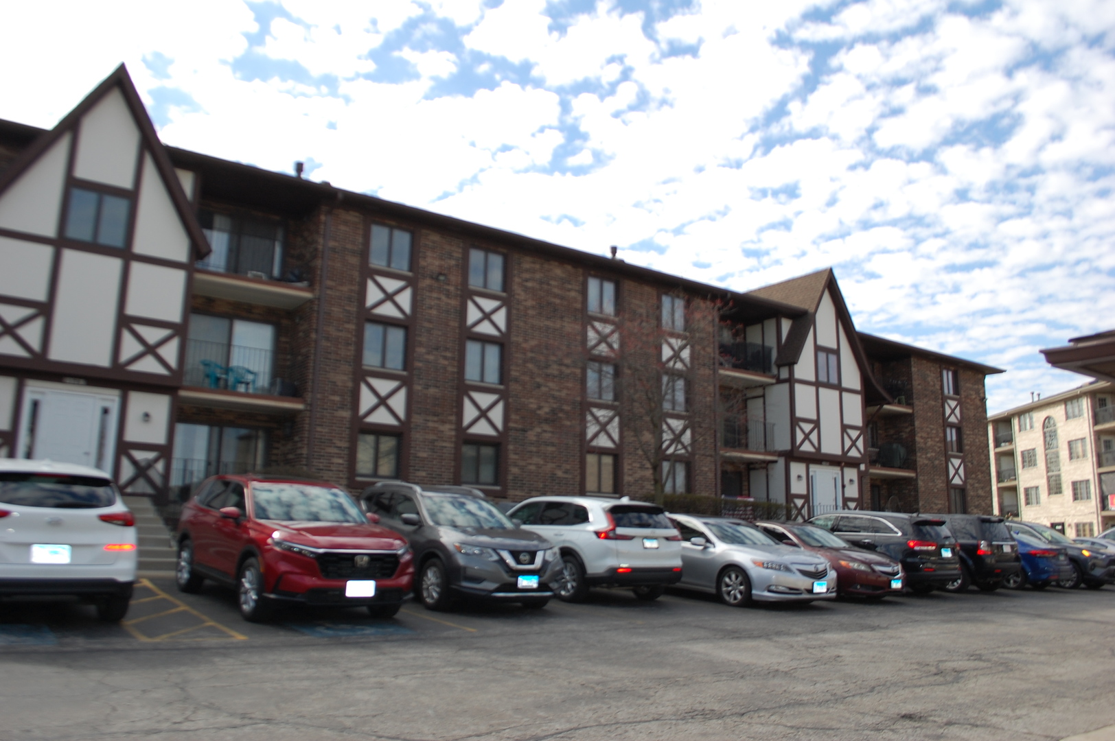 10532 Ridge Cove Drive, Unit 27A Chicago Ridge, IL 60415 - Photo 3 of 15 a city street lined with cars parked in front of a building