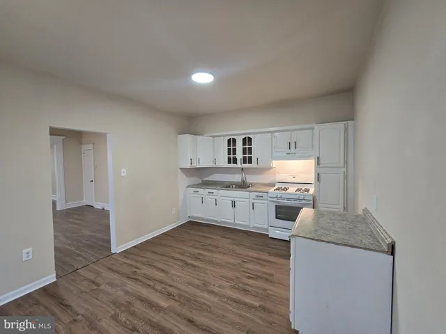 a kitchen with stainless steel appliances granite countertop a stove and cabinets