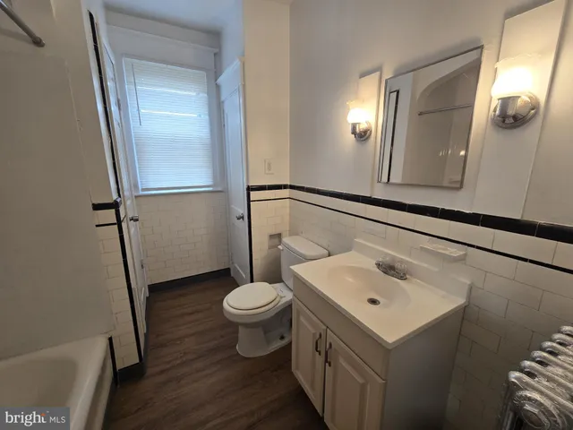 a bathroom with a sink toilet and mirror