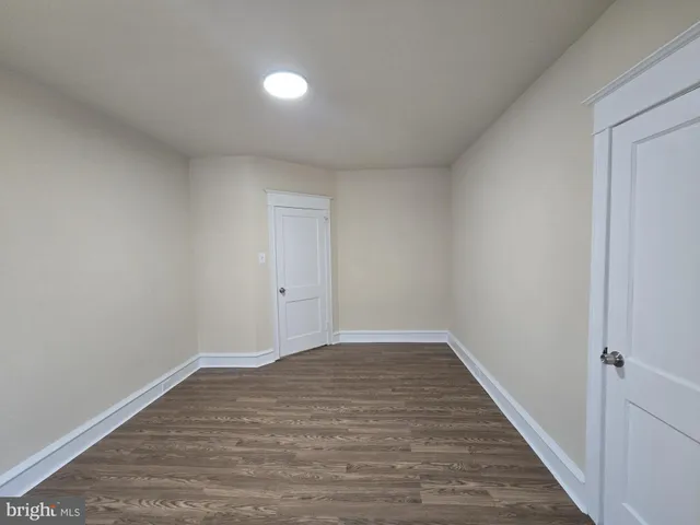 a view of an empty room and wooden floor