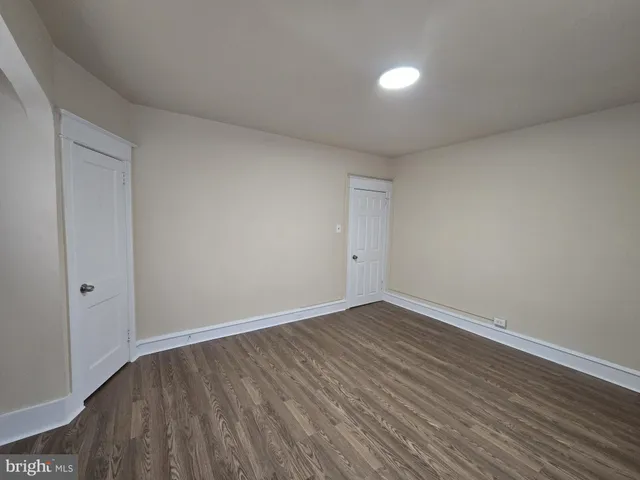 a view of an empty room and wooden floor