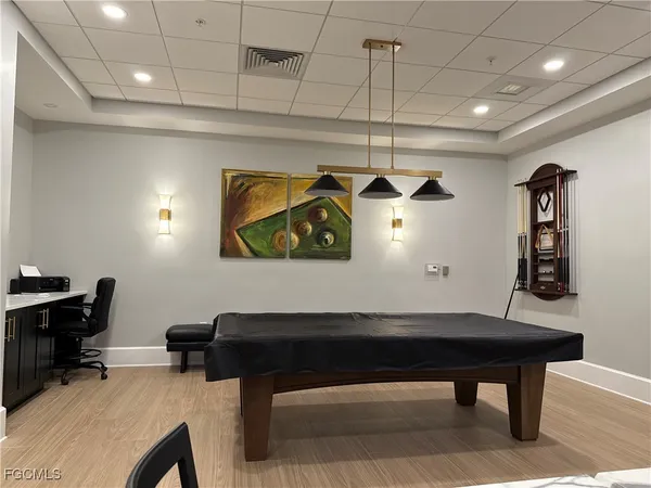 a room with furniture and paintings on wall