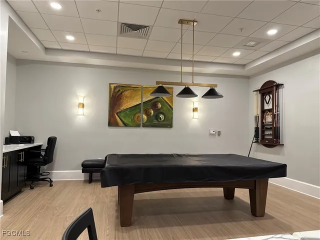 a room with furniture and paintings on wall