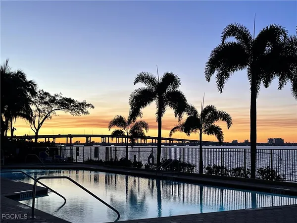 a view of swimming pool with a table and chairs