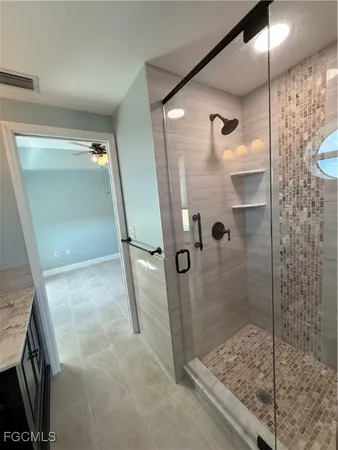 a bathroom with a glass door shower