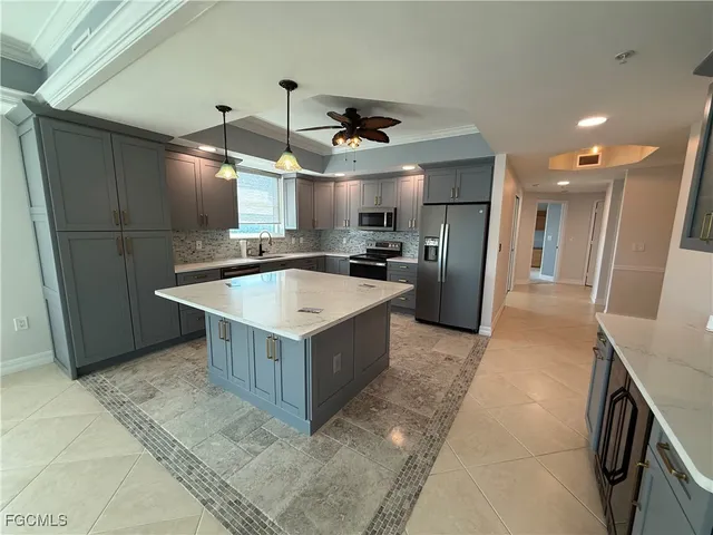 a large kitchen with a stove a refrigerator and a sink