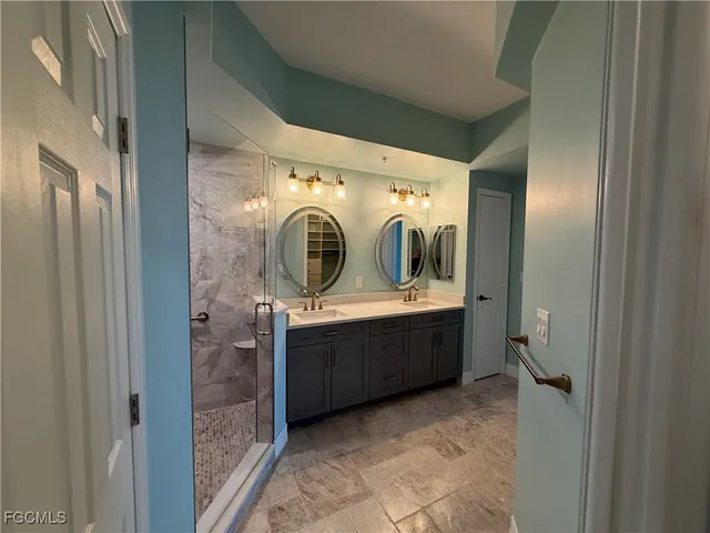 a bathroom with double vanity and mirror