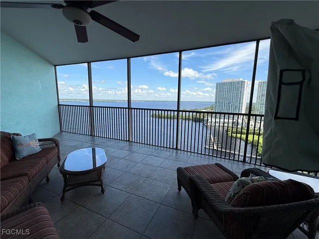 a living room with furniture and a floor to ceiling window