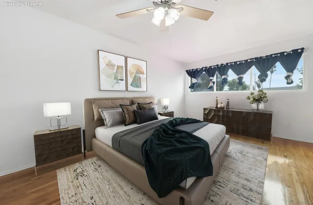 a bed room with a bed and a painting on the wall