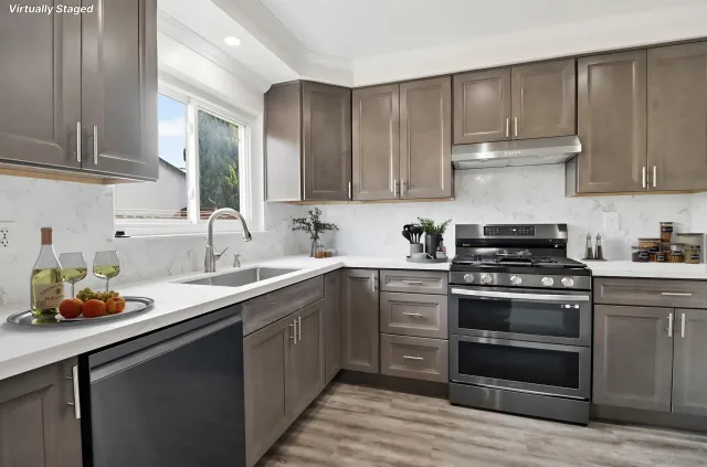 a kitchen with a sink stove and cabinets