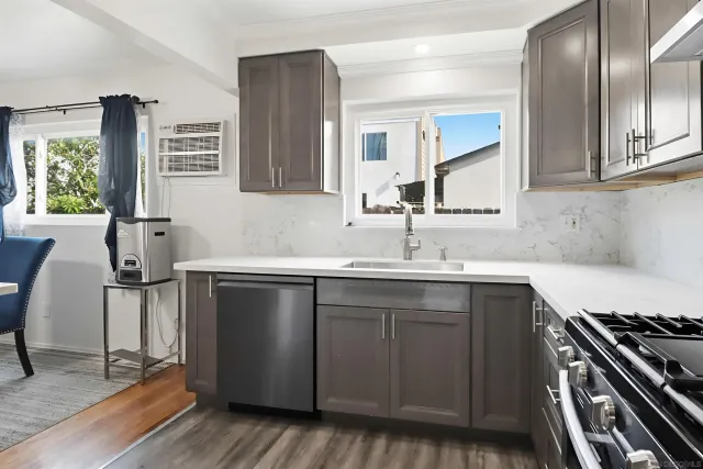 a kitchen with stainless steel appliances a sink stove and cabinets