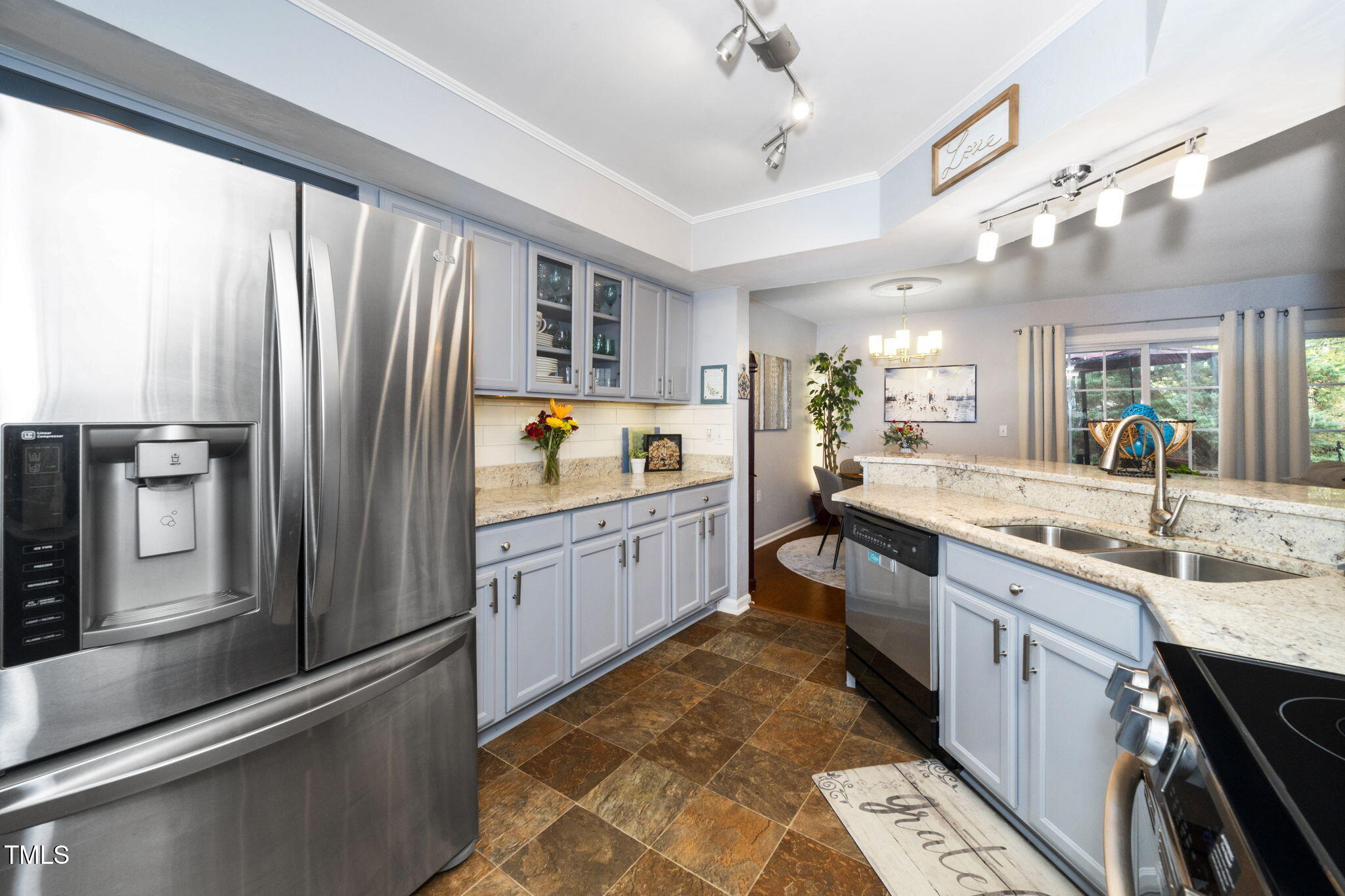 7704 Falcon Rest Circle Raleigh, NC 27615 - Photo 12 of 23 a large kitchen with a large window and stainless steel appliances