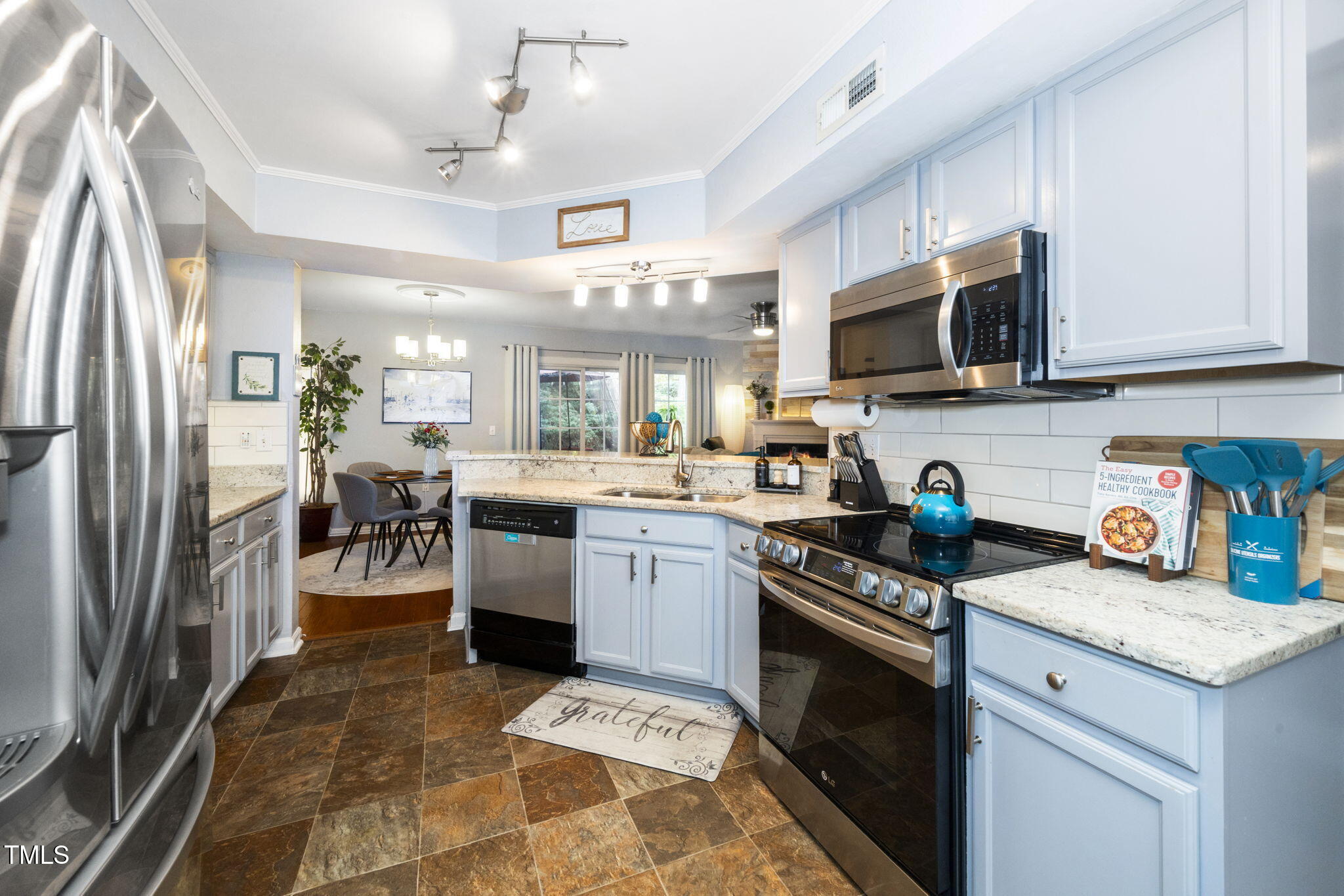 7704 Falcon Rest Circle Raleigh, NC 27615 - Photo 13 of 23 a kitchen with granite countertop a sink stainless steel appliances and counter space