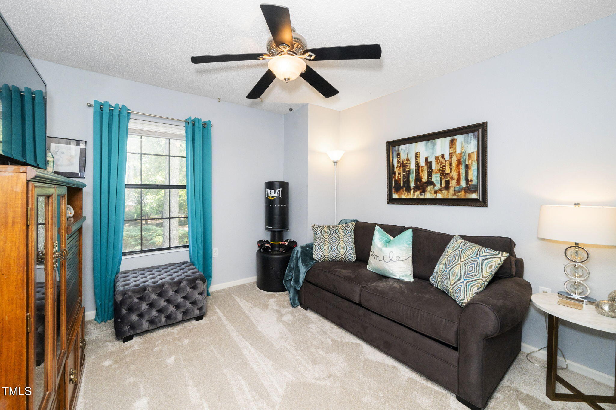 7704 Falcon Rest Circle Raleigh, NC 27615 - Photo 16 of 23 a bedroom with a bed couch and window
