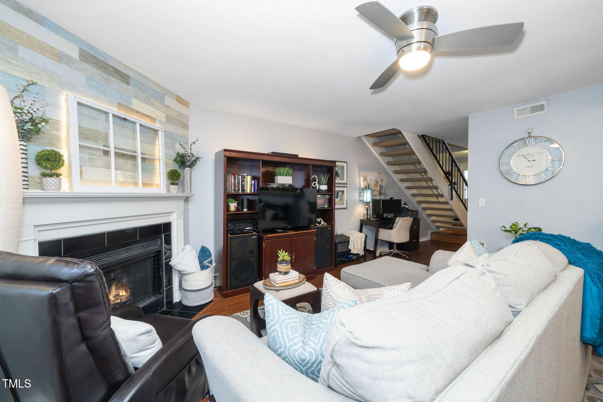 7704 Falcon Rest Circle Raleigh, NC 27615 - Photo 6 of 23 a living room with furniture a fireplace and a large window