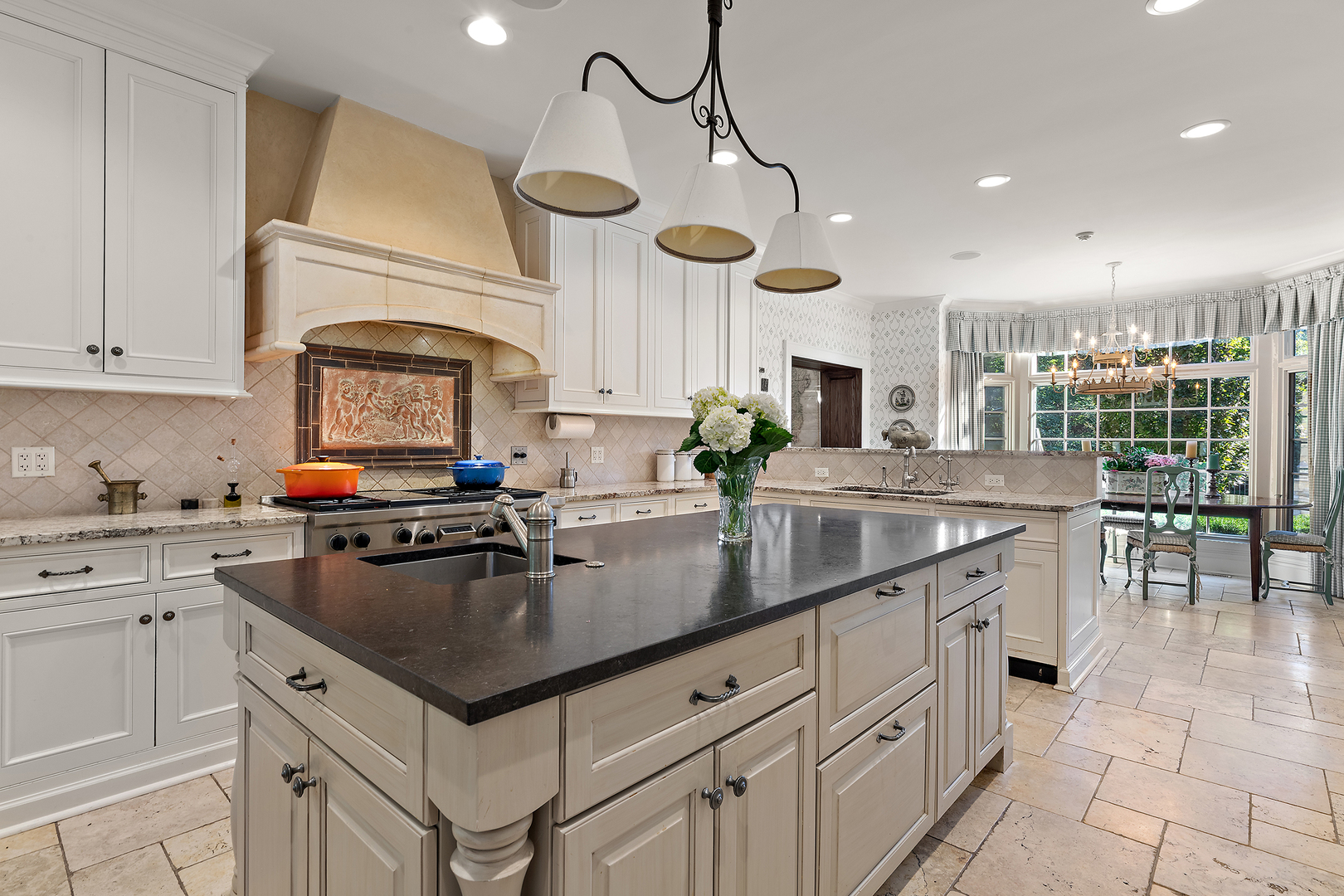 640 Hill Road Winnetka, IL 60093 - Photo 11 of 52 a kitchen with stainless steel appliances granite countertop a sink a stove and cabinets