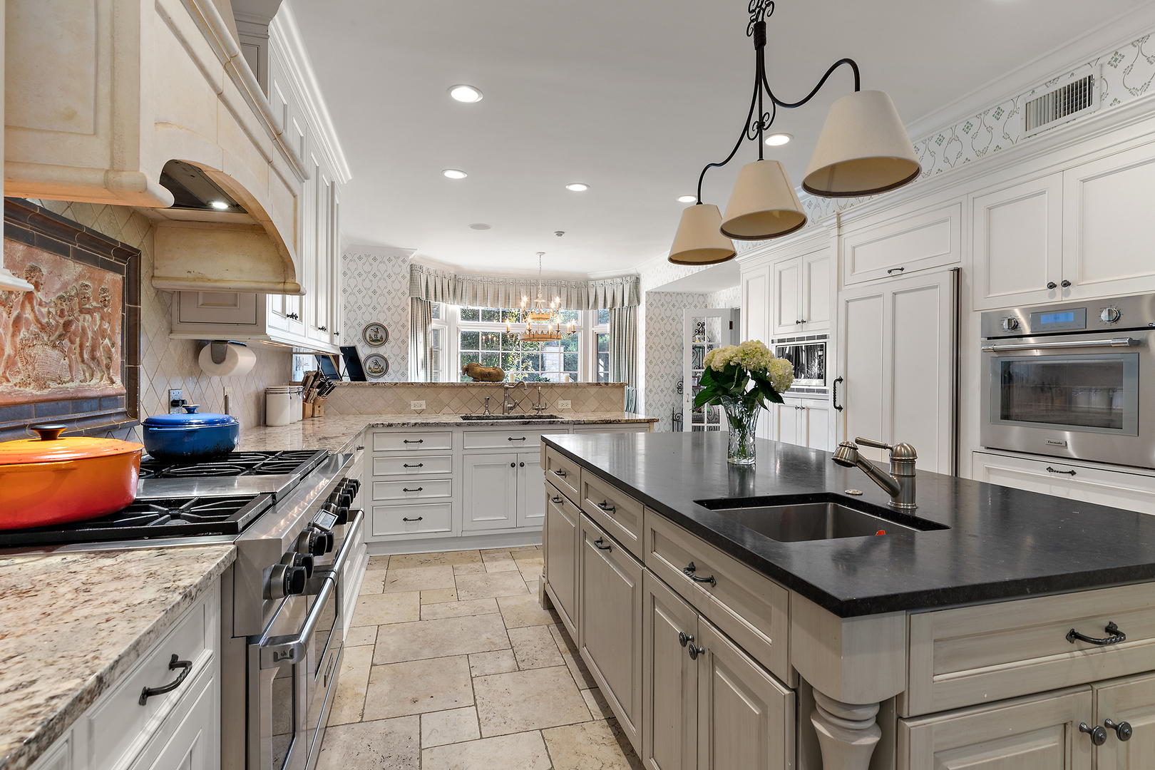 640 Hill Road Winnetka, IL 60093 - Photo 12 of 52 a kitchen with stainless steel appliances granite countertop a sink a stove and a wooden floors